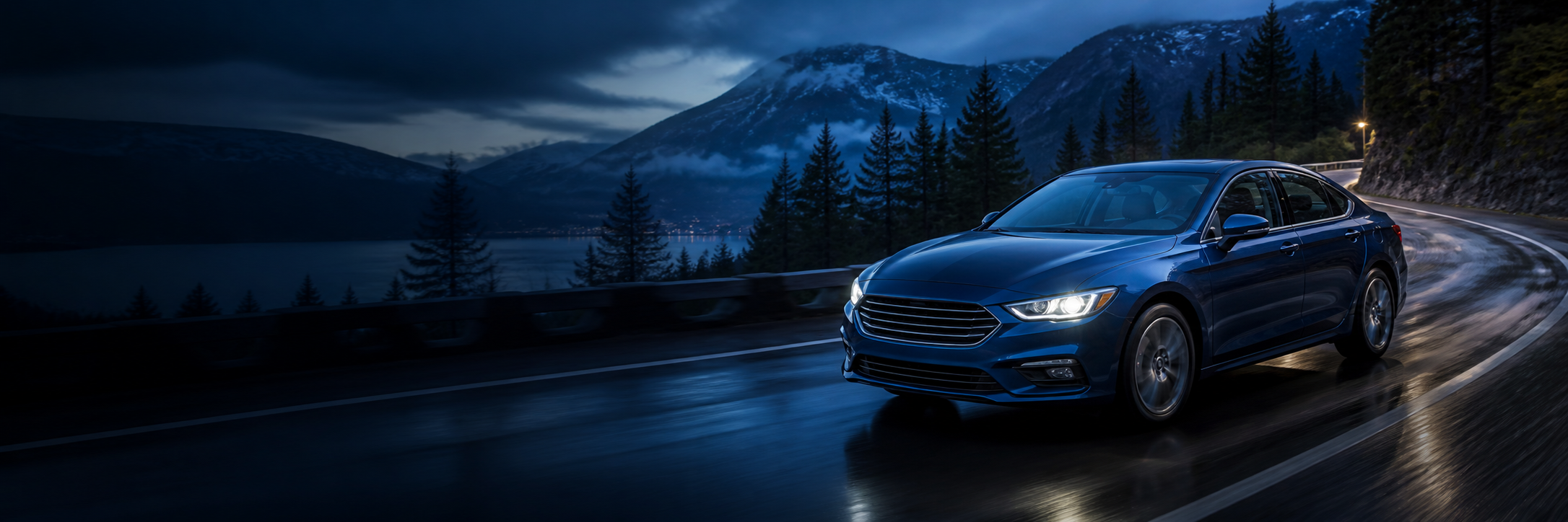 Blue sedan driving on a Pacific Northwest mountain road